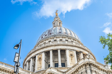 Low-angle view of the massive dome of St. Paul&rsquo;s Cathedral against a bright blue summer sky in London