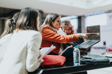 Group of colleagues gathers around a laptop, pointing at data on the screen while discussing charts and ideas. They work together in a modern, bright workspace, showcasing collaboration and teamwork.