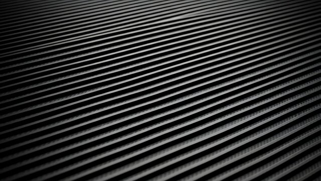 Detailed close-up of a dark ribbed surface with parallel linear textures and subtle highlights