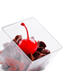 Dessert with chocolate shavings and a cherry on top in a glass container