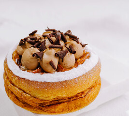 Delicious pastry topped with chocolate cream and shavings ready to enjoy