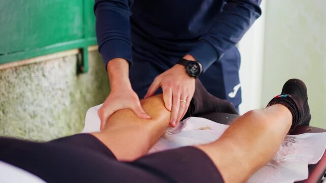 Man giving a post-sport leg massage outdoors, relaxation focus