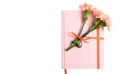 Soft pink journal adorned with coral-colored carnations tied together with an orange ribbon. The flowers rest atop the closed book