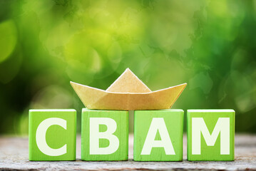CBAM text on wood and paper boat on natural background.