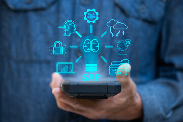SAP text on phone in hand and icons on natural background.