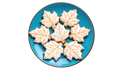 Maple leaf shaped cookies, decorated with white icing and orange veins, are arranged on a bright blue plate