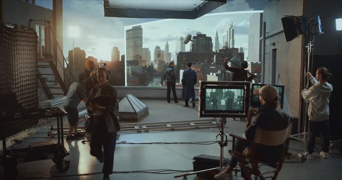 Professional Camera Operator and Cinematography Director Film Actors on a Rooftop Movie Set, Monitoring Shots on Screens, Using Virtual Production for Controlled Cinematic City