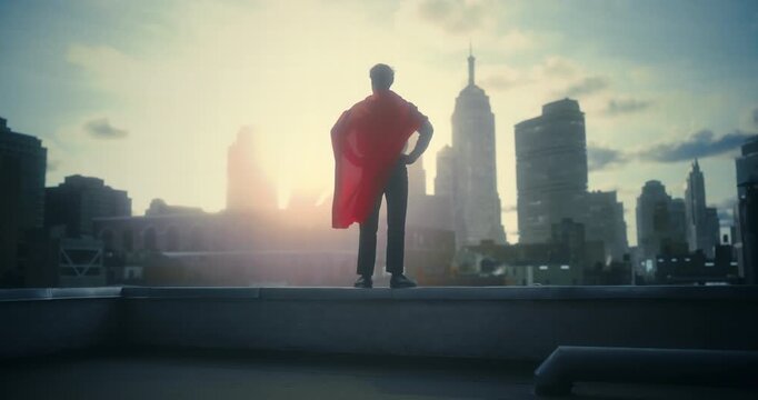 A Young White Male Superhero in a Flowing Red Cape Walks Across a Rooftop Dramatically Overlooks a Futuristic City Ready to Fight Crime. Cinematic Conceptual Mock-up Movie, Trailer Scene