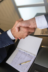Business handshake with contract