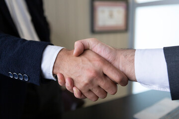 Business handshake with contract