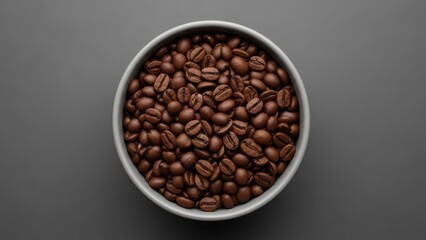 Fototapeta premium Top view of bowl filled with freshly roasted coffee beans on gray background