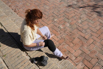 Woman preparing for exercise by putting on knee support