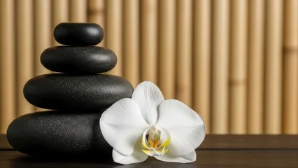 Sierkussen Spa Zen Balance - Stacked Black Stones and White Orchid Against Bamboo.  © khasanah