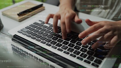Close-up of hands typing on a laptop keyboard, surrounded by coding text overlay. This image captures the essence of technology and software development in a modern workspace. Xenic