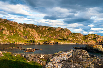 Scotland – Highlands - Oldhoremore - picturesque rocky coastal landscape with green hills, calm sea, and dramatic sky © Tommy Lee Walker