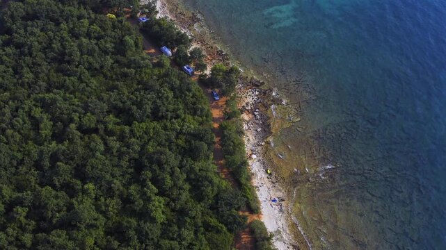 Drone view of the scenic coastline and sandy beaches of Porec, Croatia. Mediterranean seaside, tourism, summer vacation, travel  lifestyle concept.
