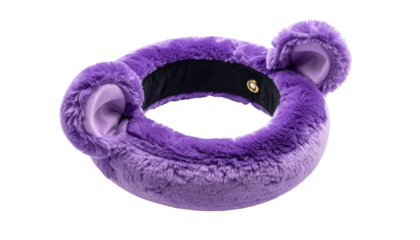 A fluffy, purple headband with attached bear-like ears sits against a black background, highlighting the accessory's texture