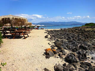 Greece - view on the Lichadonisia beach on the island of Monolia near the mainland with the town of Kamena Vourla