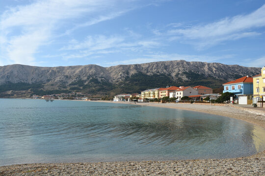 A beautiful panoramic view of the turquoise sea and pebble beach at Vela Plaza in Baska on the island of Krk in Croatia in late autumn