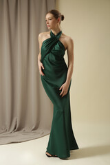 Ultra-glam statement maxi open-back silk maxi dress with tie neck and thigh-high slit. Wedding guest, formal evening events or summer parties emerald green luxury gown.