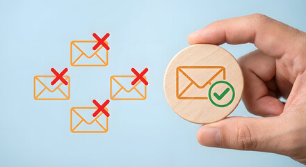 Hand Holding Wooden Stamp with Encrypted Email Icon Symbolizing Successful Email Submission
