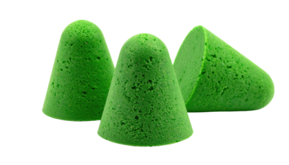 Three small green cone-shaped objects of varying sizes arranged against a stark black background. One is halved