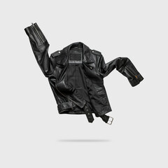 Black women's leather jacket isolated on gray background. Stylish zippered jacket with rivets made of genuine leather, cut out along contour. Clothing object for design, advertising, mockup