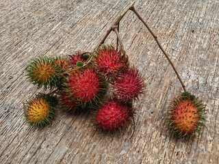 red rambutan fruit on a wooden background