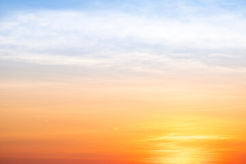 Sunset or sunrise sky with a vibrant gradient of orange, gold, and soft blue. Clear atmosphere with wispy clouds. Peaceful, natural light background. hope, freedom, new day and inspirational Concepts