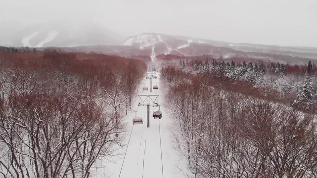 Aerial View fly Cable Car Path in Snow Covered Mount Iwaki, Winter Season, Aomori Japan