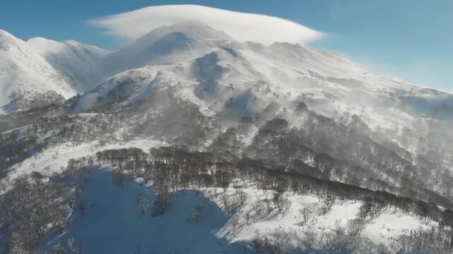 Aerial slow motion Japanese winter Landscape at the Base of Mount Iwaki, snow travel in Aomori