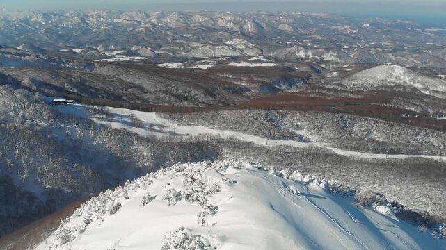 Aerial Drone fly top of Mount Iwaki Summit in Winter snowed Landscape of Japan Aomori