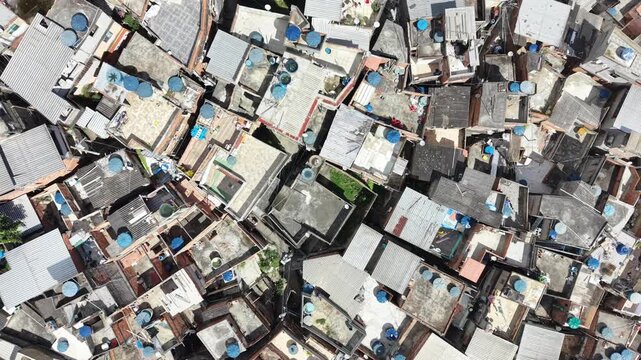 Aerial drone view of Favela Of Cantagalo, Rocinha favelas spread out on the mountain in Sao Conrado , Rio de Janeiro, Brazil.