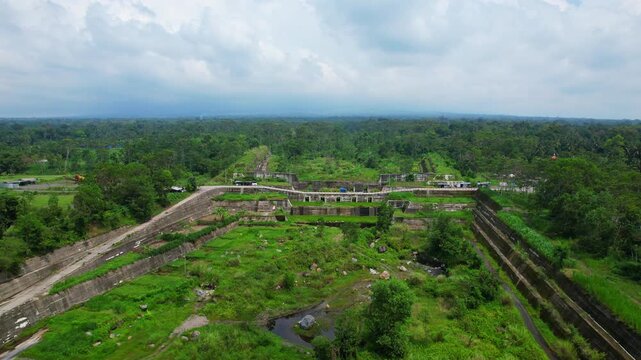 Aerial drone footage of a tropical covered with vegetation, evacuation canal in Java island, Indonesia, that is suppose to guide lava when the volcano is erupting