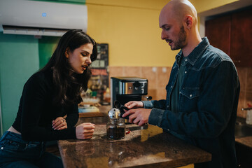 Two people share a moment as one brews coffee at a kitchen counter.