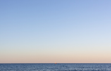Obraz premium Clear blue sky over the calm Mediterranean Sea in Sardinia, Italy, with a serene horizon during summer.