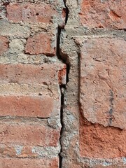 the wall is made of cracked bricks in the middle