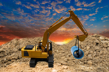 Crawler excavators  are digging the soil in the construction site. With  sky and clouds of on sunset background