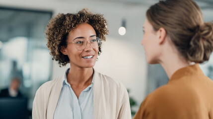 HR manager engages in constructive feedback conversation with employee in modern office, fostering professional growth and development