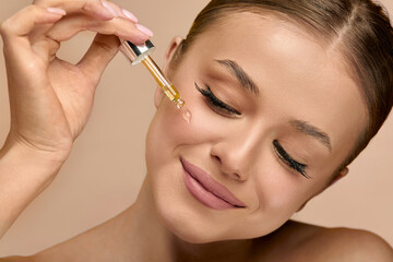 Portrait, beauty woman with serum, skincare and facial treatment for healthy skin or glow. Studio...