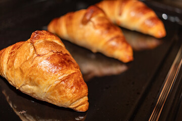 Freshly baked croissants in the oven