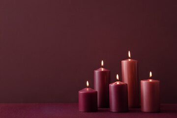 Christmas candles in dark burgundy and red tones