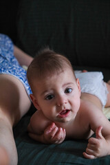 Playful Baby Lying on Bed close up