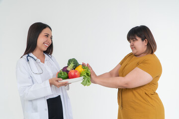 Healthy Choices: A scene of a professional offering a plate of fresh produce to an individual. A symbolic moment about choosing nutritious food.
