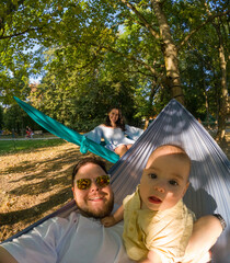 Family Relaxing in Park Hammocks Sunset time