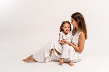 a newborn baby in its mother's arms, the mother soothes the baby before bedtime by rocking it to sleep