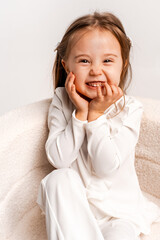 a girl child on a white cyclorama background, a girl in a white suit, a portrait, and space for text