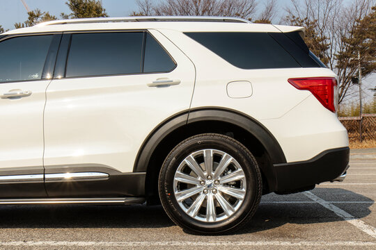 February 11, 2022, Seoul, South Korea - The rear side view of a white Ford Explorer PHEV parked in a lot.