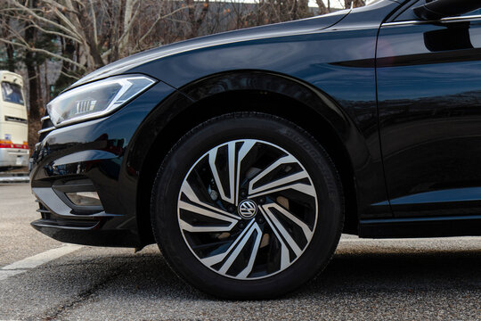 January 23, 2022, Seoul, South Korea - A close-up view of the front wheel and headlight of a black Volkswagen Jetta sedan.