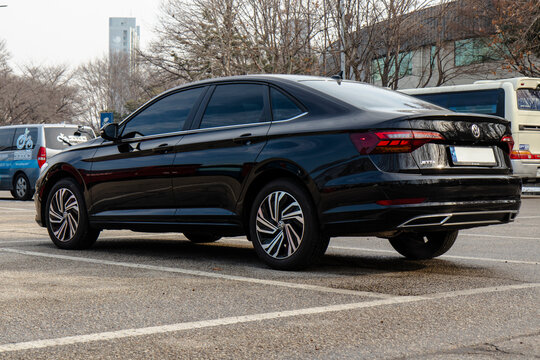 January 23, 2022, Seoul, South Korea - A black Volkswagen Jetta sedan parked in an outdoor parking lot during the day.